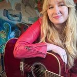 florence sommerville holding a guitar