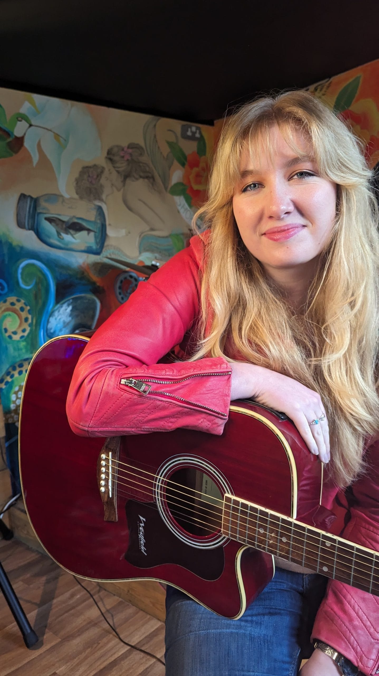 florence sommerville holding a guitar